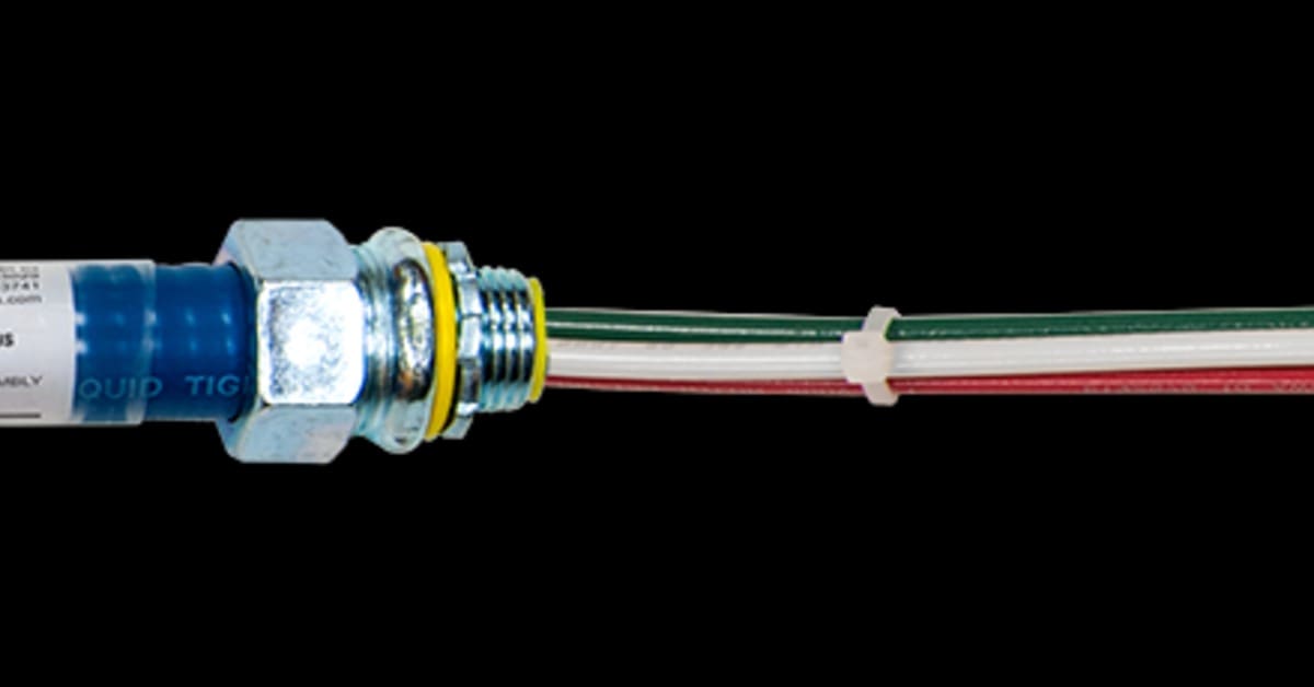A long power cable assembly with a metal box, blue connectors, labels, exposed wires, and white sleeve.