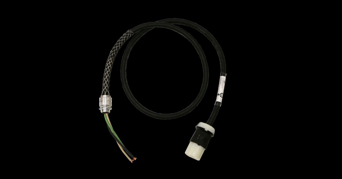 A black cable loops across a black surface, ending in a white connector and green, white, and black stripped wires.
