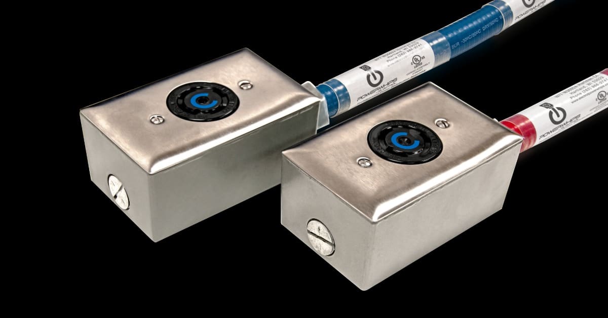 Two metal electrical boxes on a plain black background are attached to blue and red conduit sections.